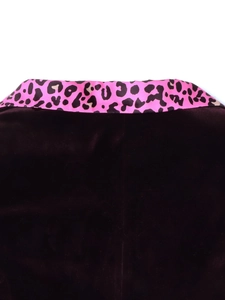 Detailed close-up of velvet blazer collar with vibrant pink leopard print satin lapel