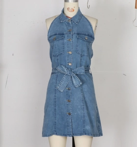 Detail of blue denim dress with metal buttons, shirt collar and waist tie bow