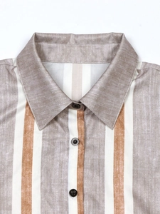 Relaxed vertical striped shirt dress with a classic turn-down collar and button detail