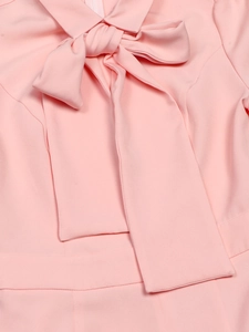 Close-up of elegant pink bow collar detail on a stylish long-sleeved dress