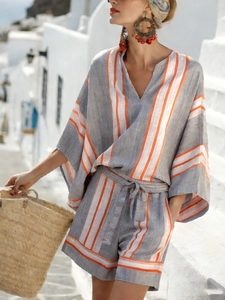 Detail of striped bohemian resort set featuring V-neck top and belted shorts