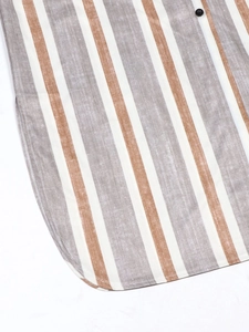 Macro detail of vertical striped shirt showing curved hemline and a black button