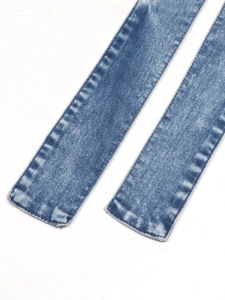 Close-up of blue denim dress featuring white snow wash texture and precise stitching detail