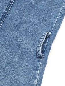 Detail of stone-washed denim dress showing high-quality stitching and belt loops