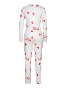 Detail of white women's romper featuring red hearts and LOVE print on the back fabric