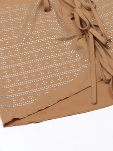 Dettaglio del top kaki con strass luccicanti e lacci laterali regolabili