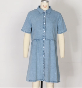 Detail of light blue denim shirt dress with white buttons and classic lapel collar