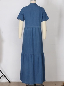 Rear view of a blue denim maxi dress featuring short sleeves and tiered cake skirt layers
