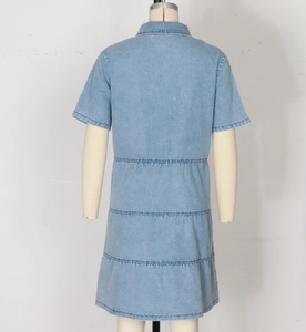 Rear view detail of a light blue tiered denim dress with short sleeves and lapel collar
