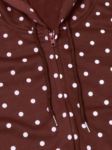 Detailed macro view of polka dot pattern on burgundy hooded jacket with resin zipper
