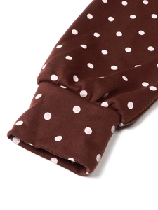 Detailed macro view of elastic ribbed cuffs on a brown polka dot zipper hoodie