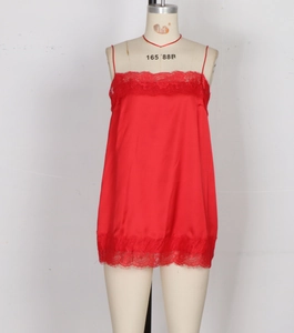 Close-up of red satin camisole dress featuring delicate eyelash lace trim and thin straps
