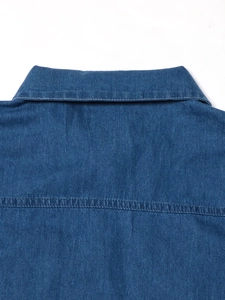 Detailed back view of a blue denim dress showing standard collar and double-stitch yoke