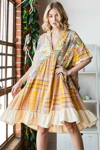 Detail of V-neck patchwork dress with floral patterns and ruffled hemline
