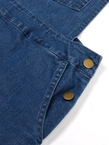 Detail of vintage blue denim dress showing bronze buttons and double-stitched side pocket