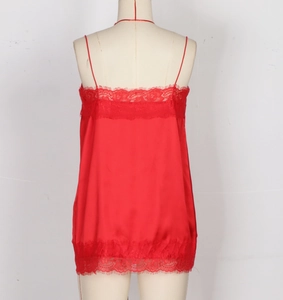 Detail view of red silk camisole dress with delicate lace trim on hem and straps