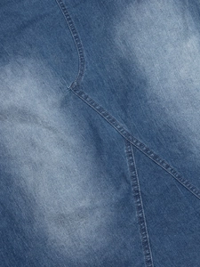 Detailed close-up showing stitching and vintage washed texture of the blue denim dress