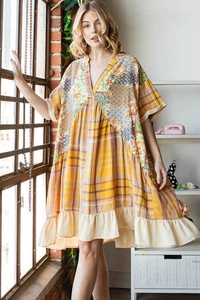 Detail of bohemian patchwork dress featuring V-neckline and intricate floral ethnic patterns