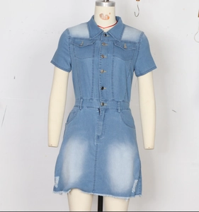 Detail of short sleeve denim dress showing washed blue fabric and chest flap pockets
