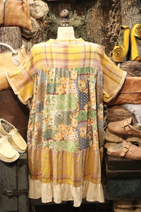 Detailed back view of a boho patchwork V-neck dress with floral print and ruffle hem