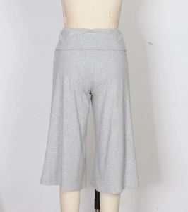 Detailed view of light gray wide-leg cropped trousers with high fold-over waistband