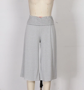 Detail of grey and white striped wide-leg pants with elastic high waistband and soft texture