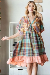 Detail of V-neck summer dress with patchwork floral and plaid patterns and ruffled hem