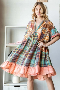 Close-up of bohemian patchwork summer dress with V-neckline and vibrant floral print