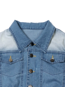 Close-up of a denim dress with classic collar, flap pockets, and washed texture detail