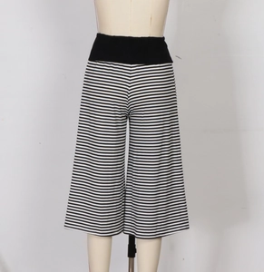 Detail of high-waisted black and white striped wide-leg culottes with a soft knit texture