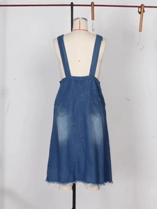Back view of vintage denim overall dress with adjustable straps and frayed hem detail
