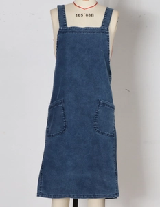 Detailed front view of washed dark blue denim apron dress with two large front pockets