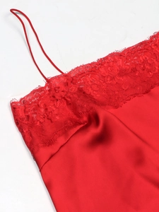 Detailed view of red satin camisole with delicate eyelash lace trim and thin straps
