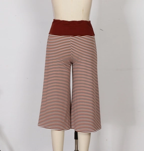 Detail of high-waist elastic band and brown striped fabric of wide-leg casual pants