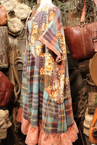 Detail of bohemian patchwork dress with orange floral prints and ruffled hemline