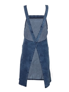 Detail of cross-back denim apron dress showing dark blue washed fabric and V-shaped back style
