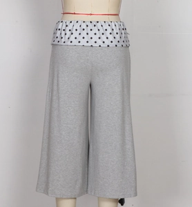 Close-up of grey wide-leg culottes featuring a black and white polka dot elastic waistband