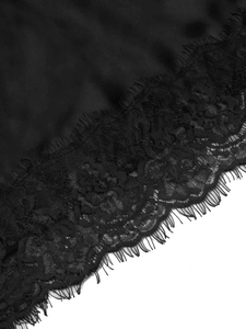 Close-up of intricate black eyelash lace detailing with floral crochet patterns