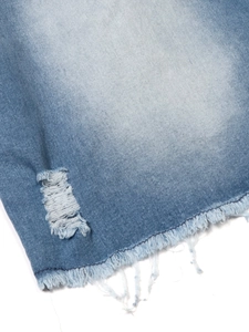 Detail of light blue denim dress showing distressed texture and frayed hemline finish