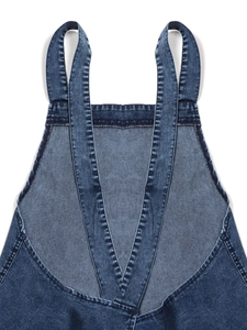 Detail of dark blue washed denim dress showing sturdy straps and clean stitching quality