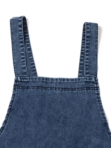 Detail of wide straps and neckline on a dark blue washed denim pinafore dress