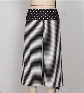 Detail view of high-waist women's shorts with polka dot belt and horizontal stripes