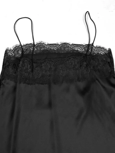 Detailed view of women's black satin camisole featuring delicate eyelash lace trim and thin straps