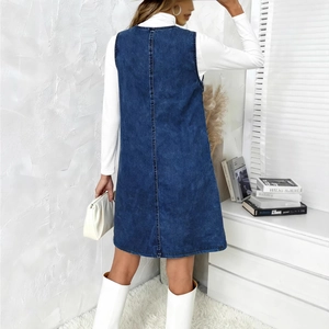 Detail view of the back seams and tailored fit of a dark blue denim sleeveless dress