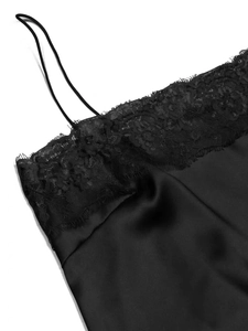 Detail shot of black satin camisole featuring delicate floral lace trim and eyelash edges