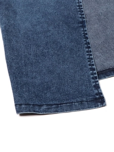 Detailed macro view of deep blue denim fabric with reinforced double-stitch hem finishing