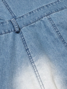 Detail of gradient wash denim dress showing belt loops and high-quality stitching