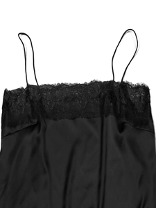 Detailed view of black satin camisole featuring delicate eyelash lace trim and thin straps