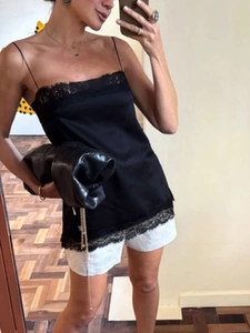 Women's black satin camisole top with lace trim and spaghetti straps in a casual style