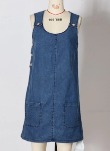 Detailed front view of a denim strap dress featuring wooden buttons and large square pockets